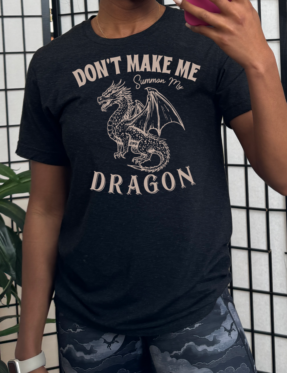 black unisex tee with the words "don't make me summon my dragon" on it, surrounding the graphic of a fierce-looking dragon