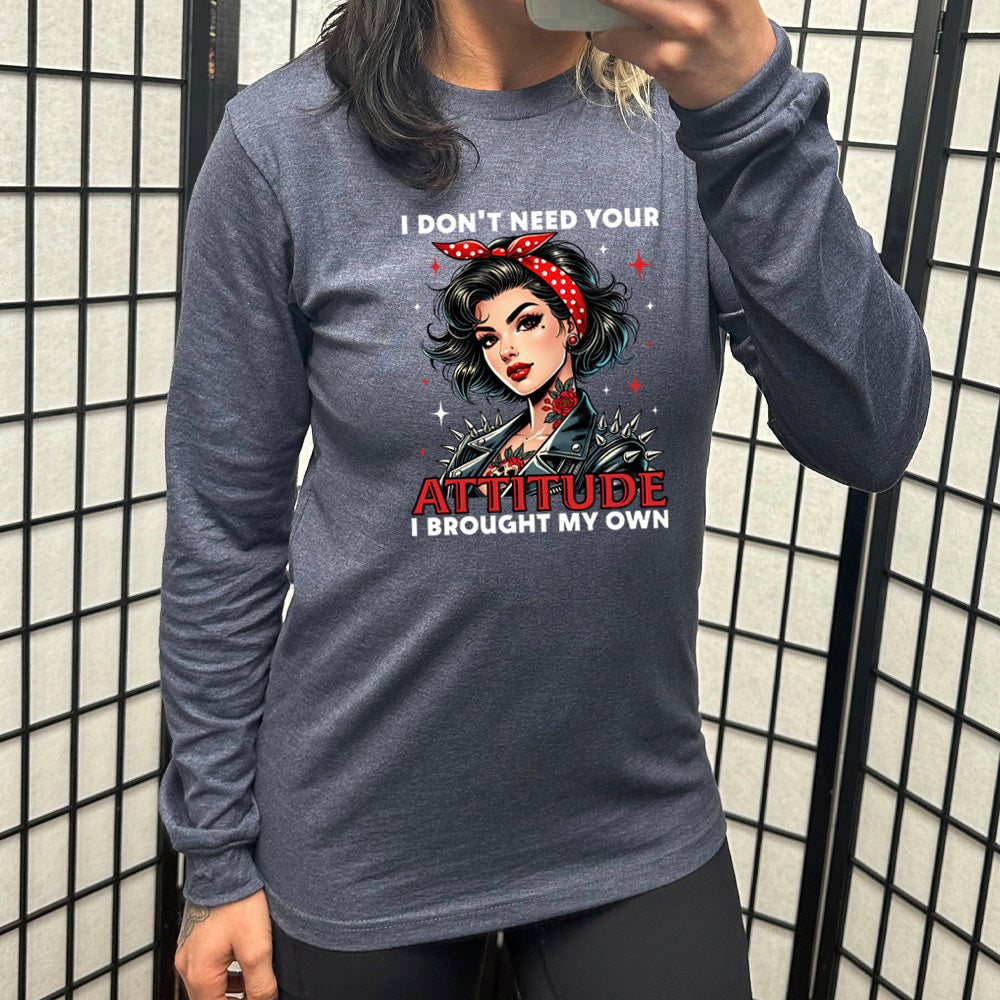 heather navy long sleeve shirt with the text "I Don't Need Your Attitude I Brought My Own" on it, with the graphic of a biker-style glamorous woman with a headband and tattoos