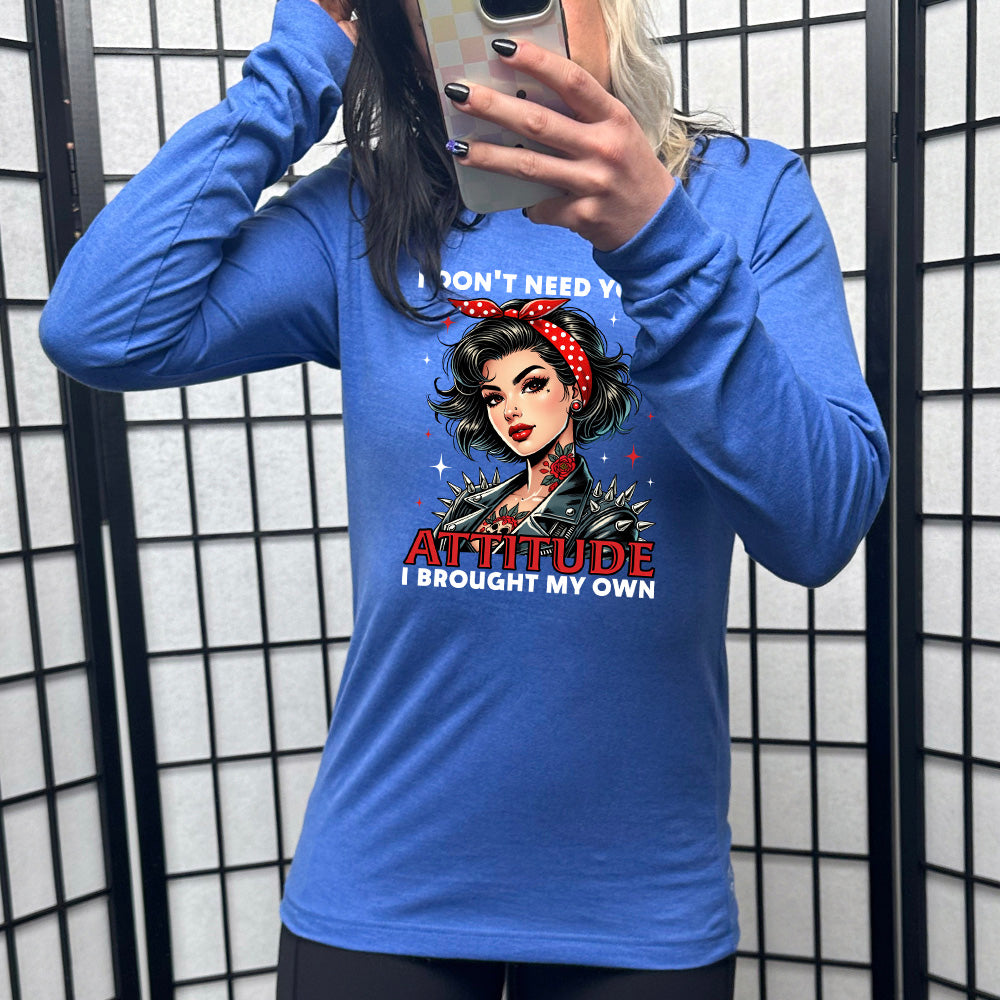 heather true royal long sleeve shirt with the text "I Don't Need Your Attitude I Brought My Own" on it, with the graphic of a biker-style glamorous woman with a headband and tattoos