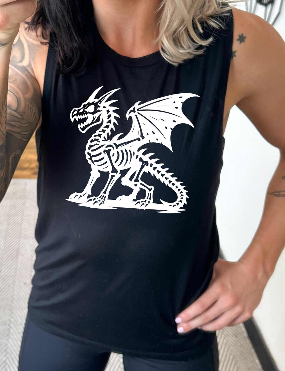black muscle tank with the large graphic of a dragon, and its body is its skeleton