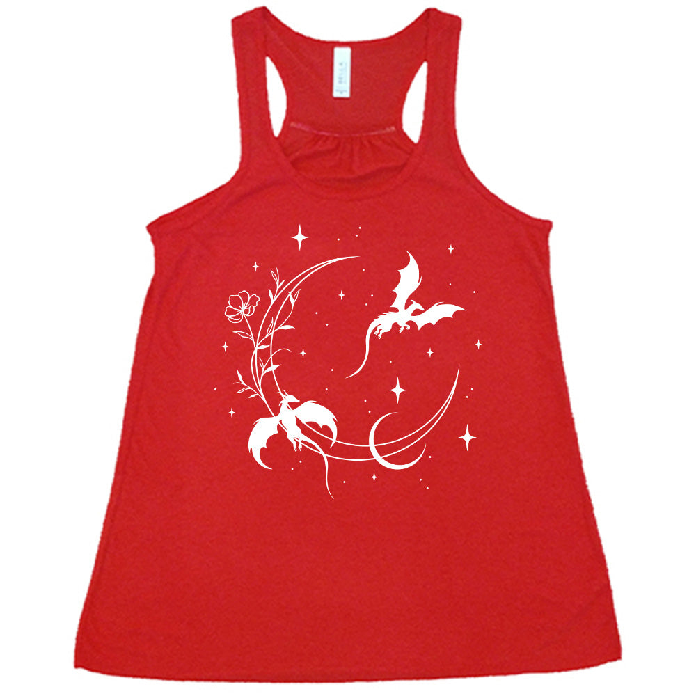 red racerback flowy tank with the graphic of a large crescent moon, with a flower lining it, two dragons flying, another smaller moon,  and many small stars