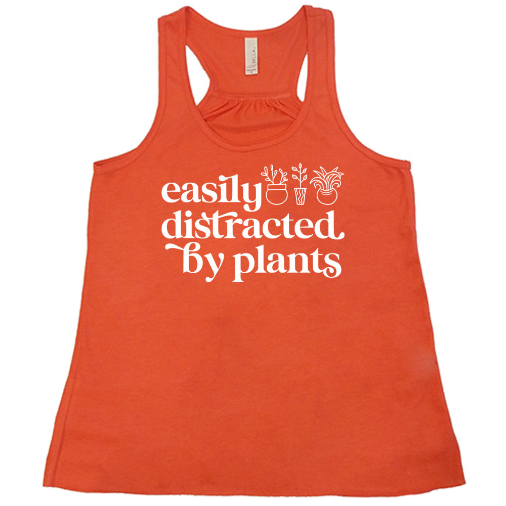 Coral colored flowy tank with a potted plant graphic on it that says "Easily Distracted By Plants"