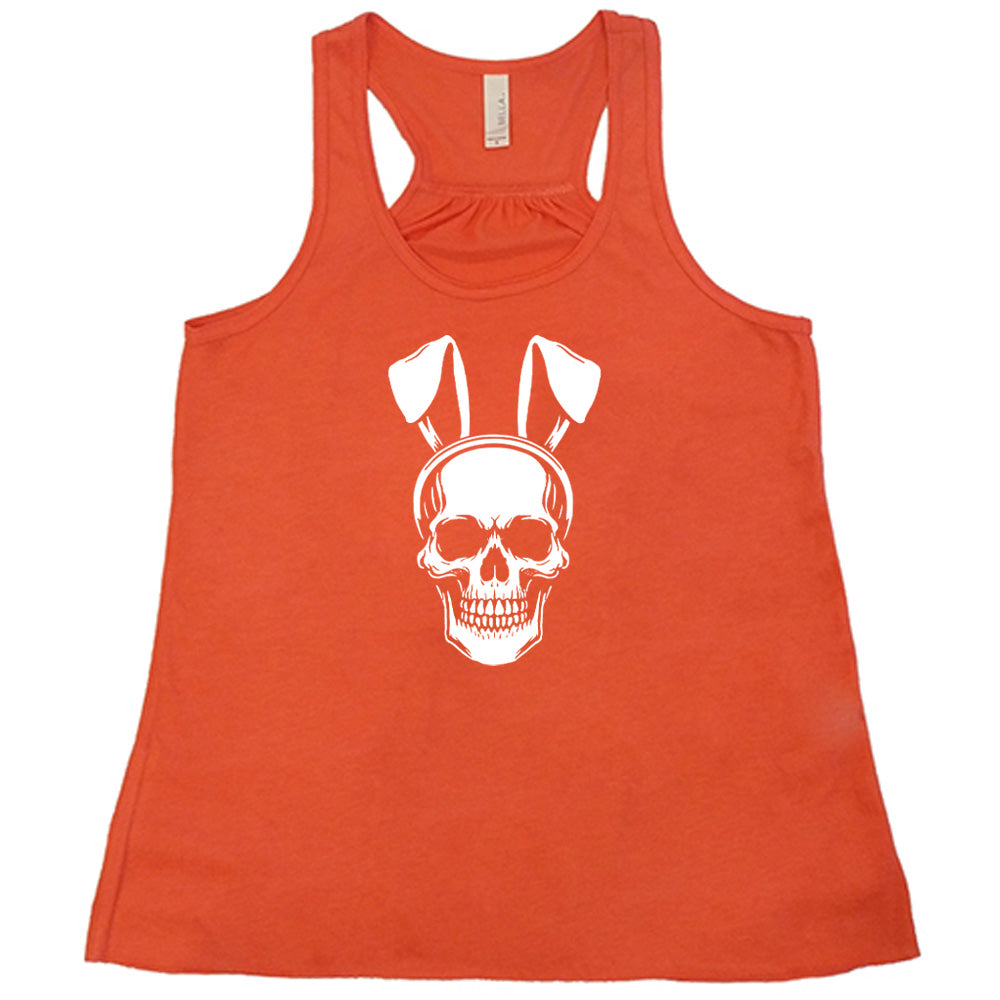 Coral colored flowy tank with a skull wearing bunny ears graphic on it