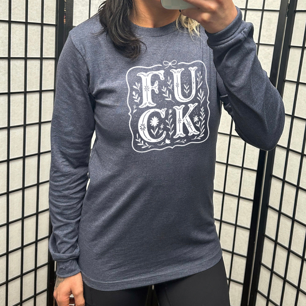 heather navy long sleeve shirt that has the word "FUCK" in large, flowery font, spaced out so that the F and U are directly above the C and K, and the word is surrounded by a a few branches and a boarder