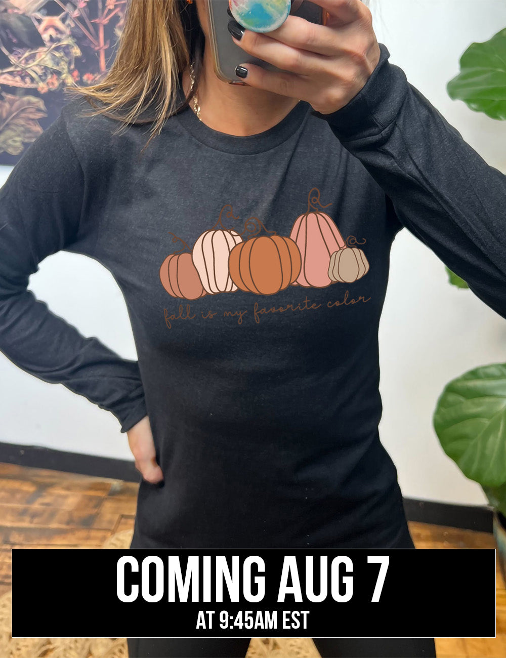 heather black long sleeve shirt with the graphic of five pumpkins of varied shape and color, and the small words underneath saying "fall is my favorite color" coming august 7th