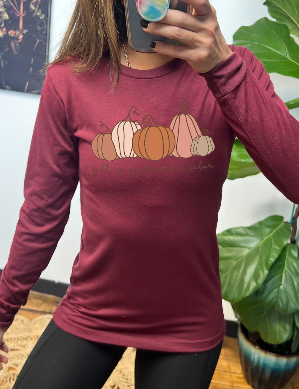 heather cardinal long sleeve shirt with the graphic of five pumpkins of varied shape and color, and the small words underneath saying "fall is my favorite color"