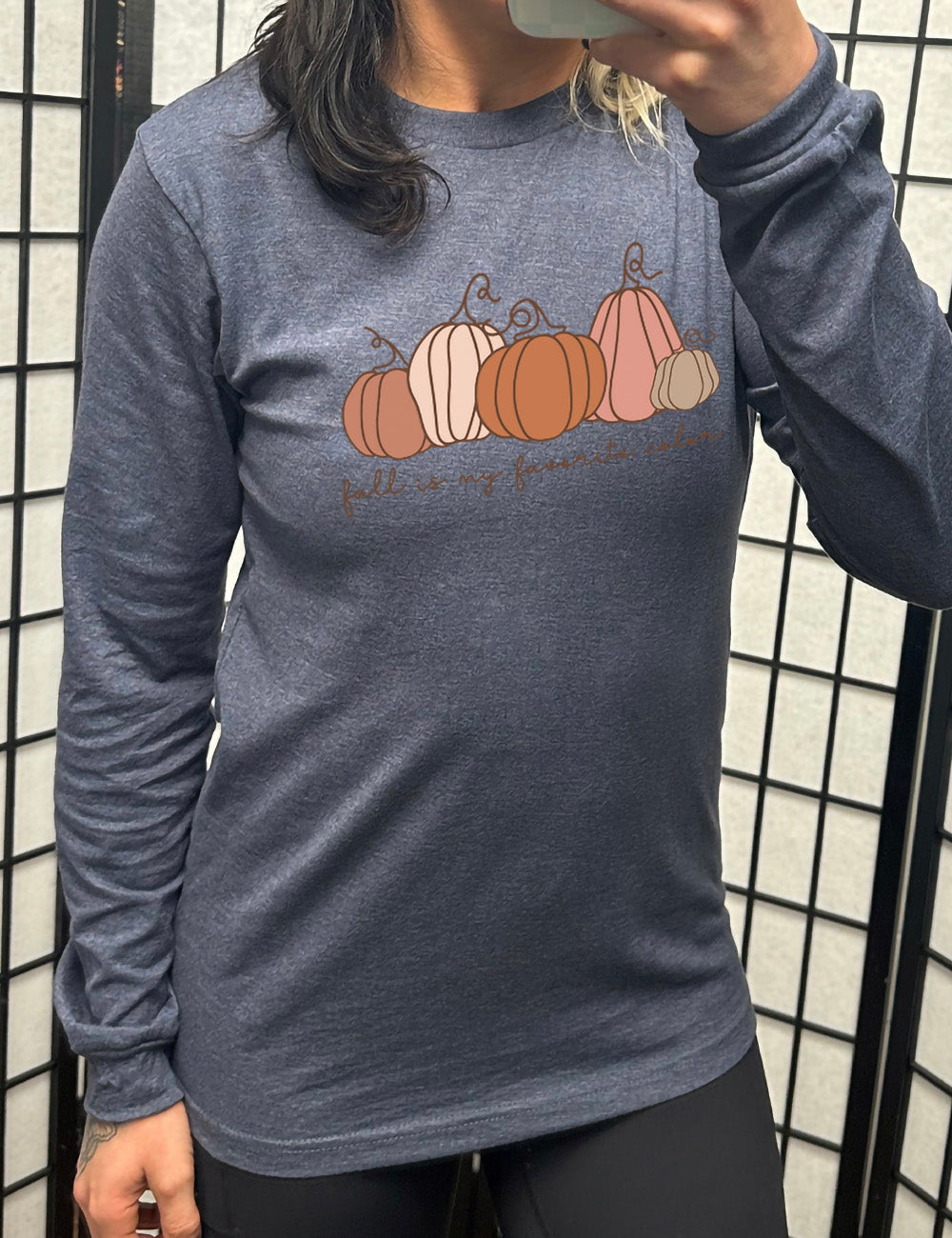 heather navy long sleeve shirt with the graphic of five pumpkins of varied shape and color, and the small words underneath saying "fall is my favorite color"