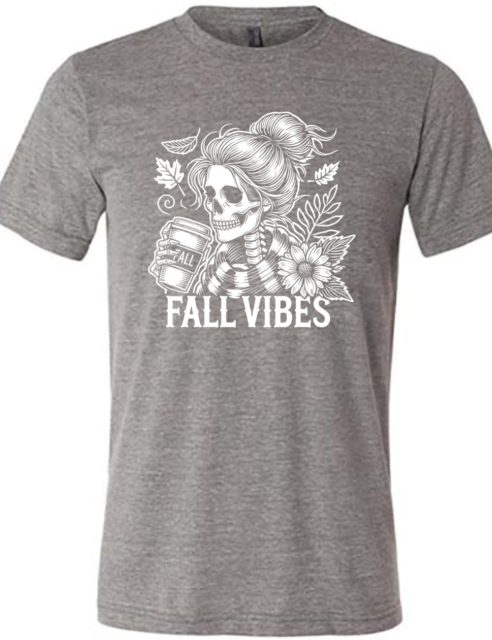 grey unisex tee with the graphic of a skeletal woman, with her hair in a bun, holding a takeaway coffee cup labeled "fall", with a flower and leaves next to her, and the words underneath saying "fall vibes"