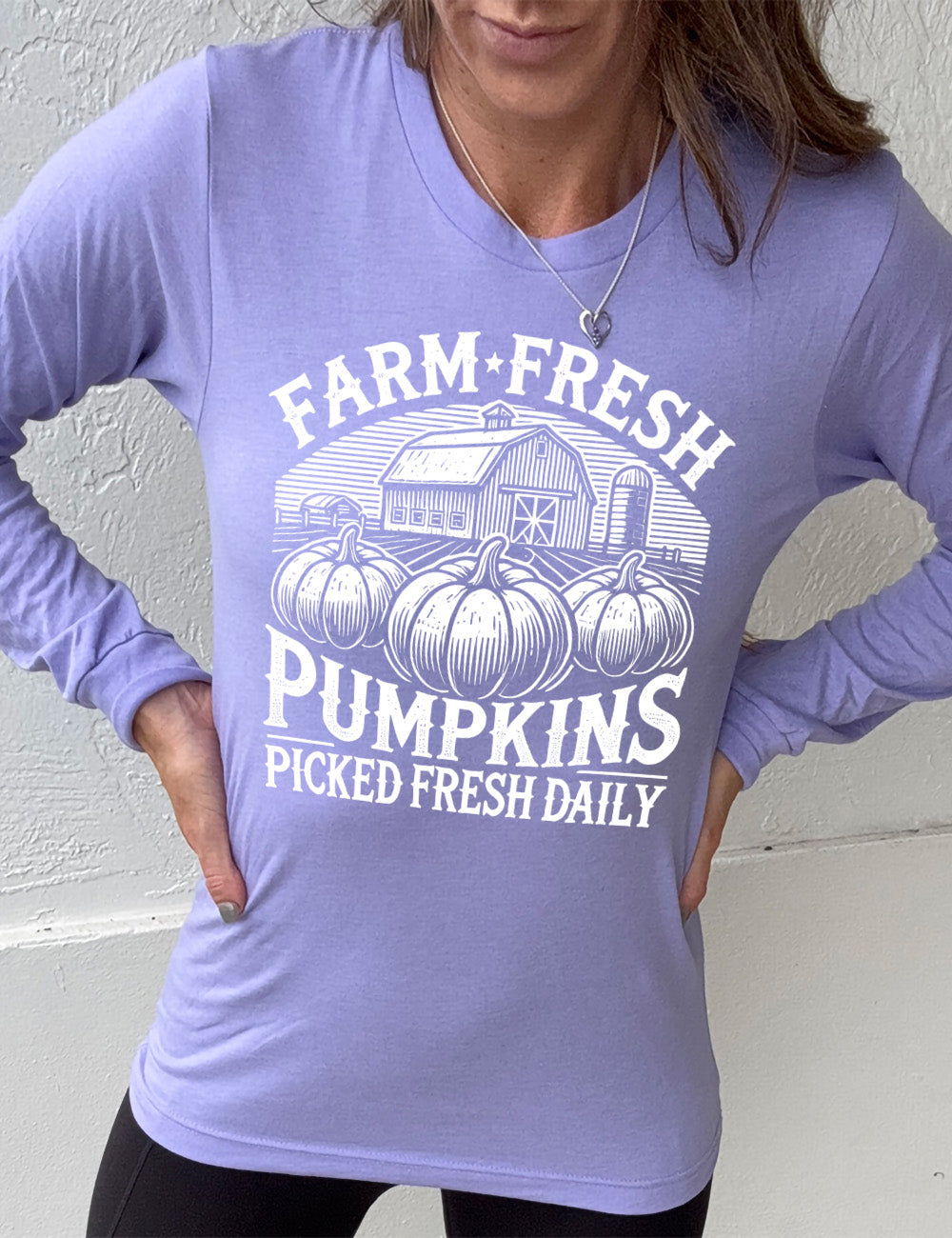 heather dark lavender long sleeve shirt with the words "farm fresh pumpkins picked fresh daily" around the graphic of a barn in the background and three pumpkins in the foreground