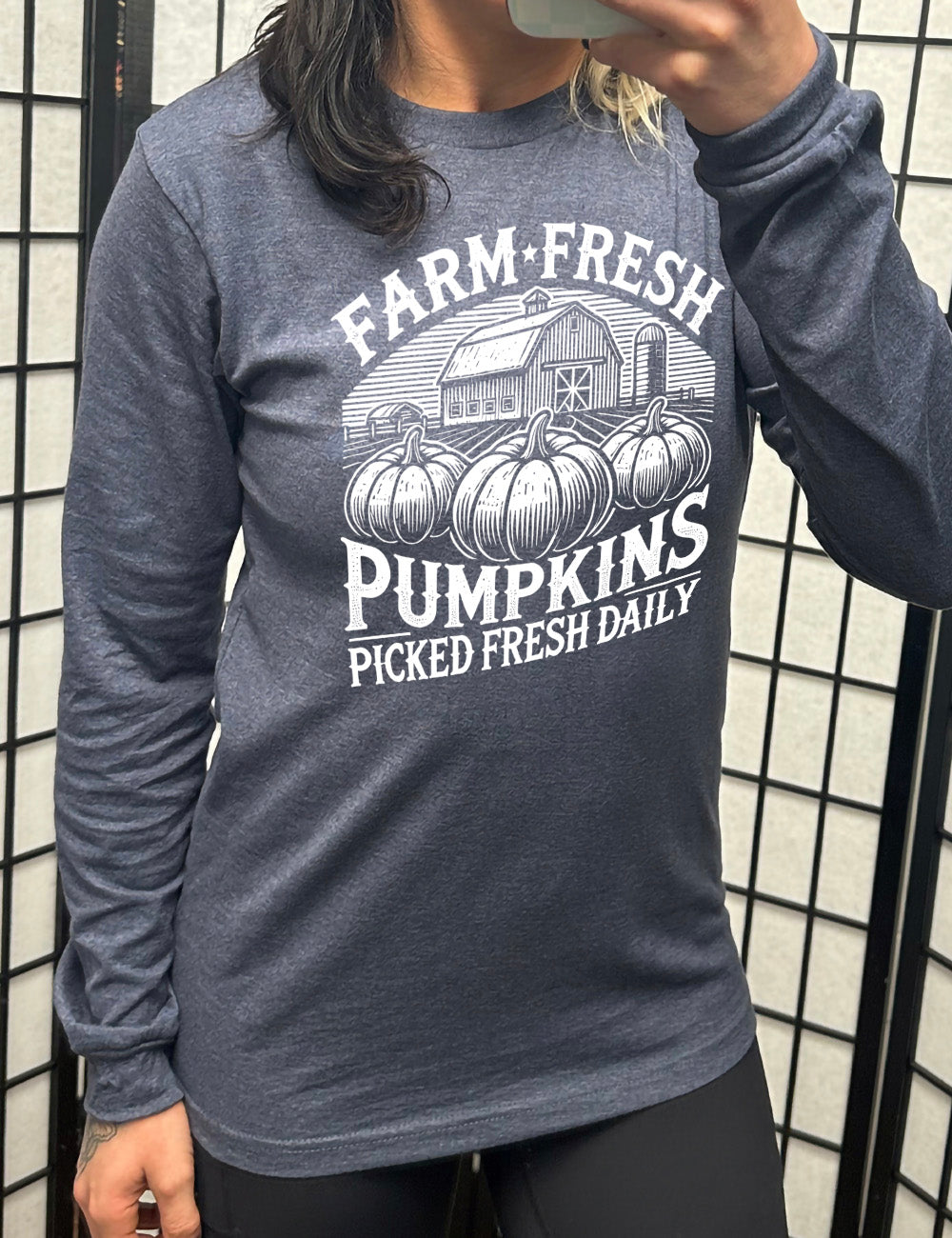 heather navy long sleeve shirt with the words "farm fresh pumpkins picked fresh daily" around the graphic of a barn in the background and three pumpkins in the foreground