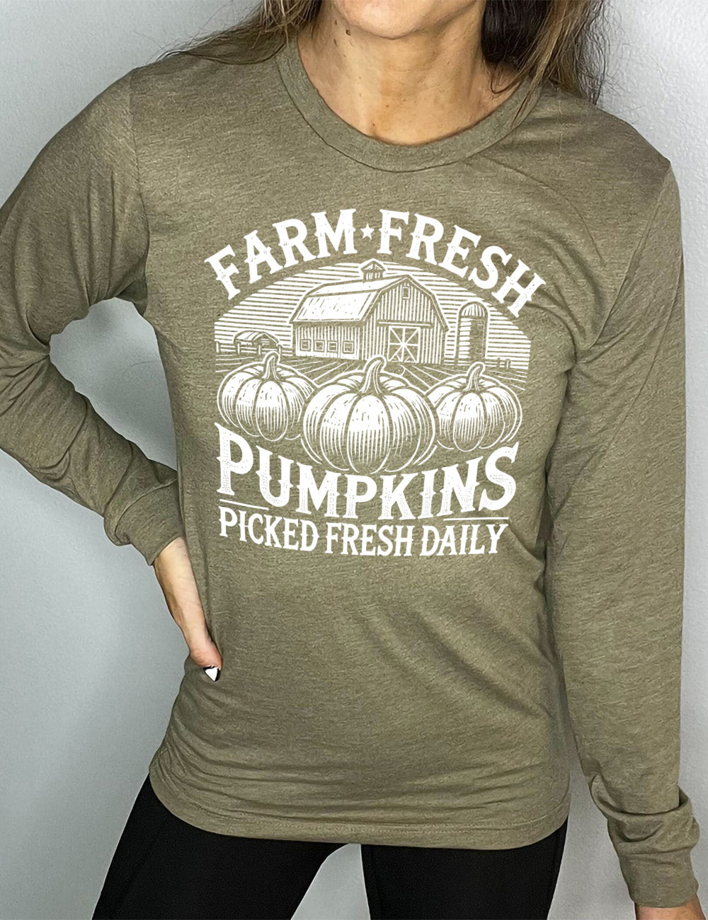heather olive long sleeve shirt with the words "farm fresh pumpkins picked fresh daily" around the graphic of a barn in the background and three pumpkins in the foreground