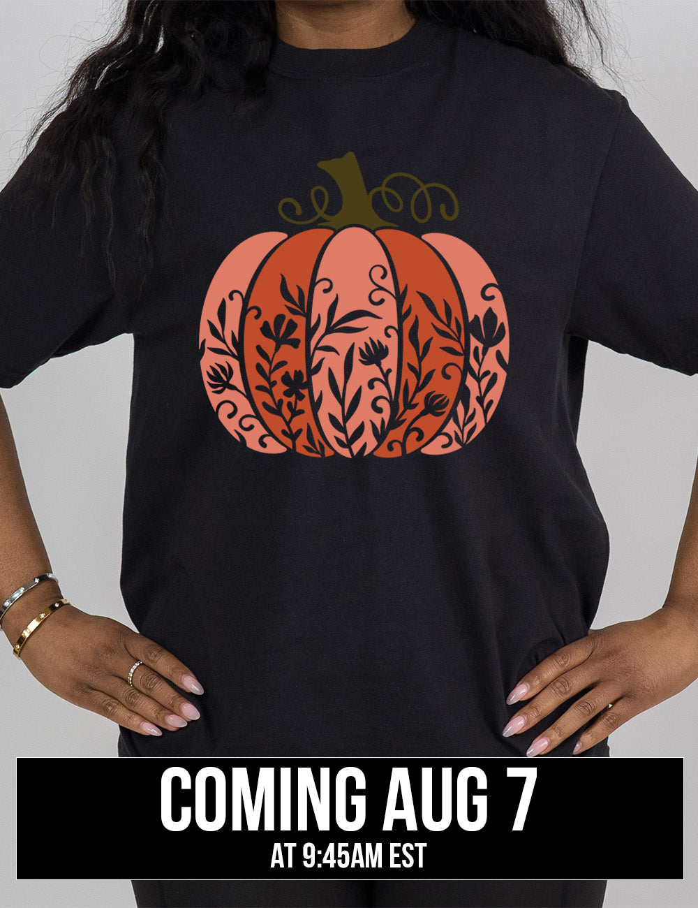 black modern tee with the colorful graphic of a pumpkin, with vines in silhouette on it coming august 7th