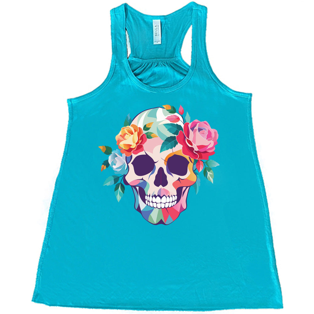 teal flowy racerback tank with the colorful graphic of a skull, with flowers adorning it's head