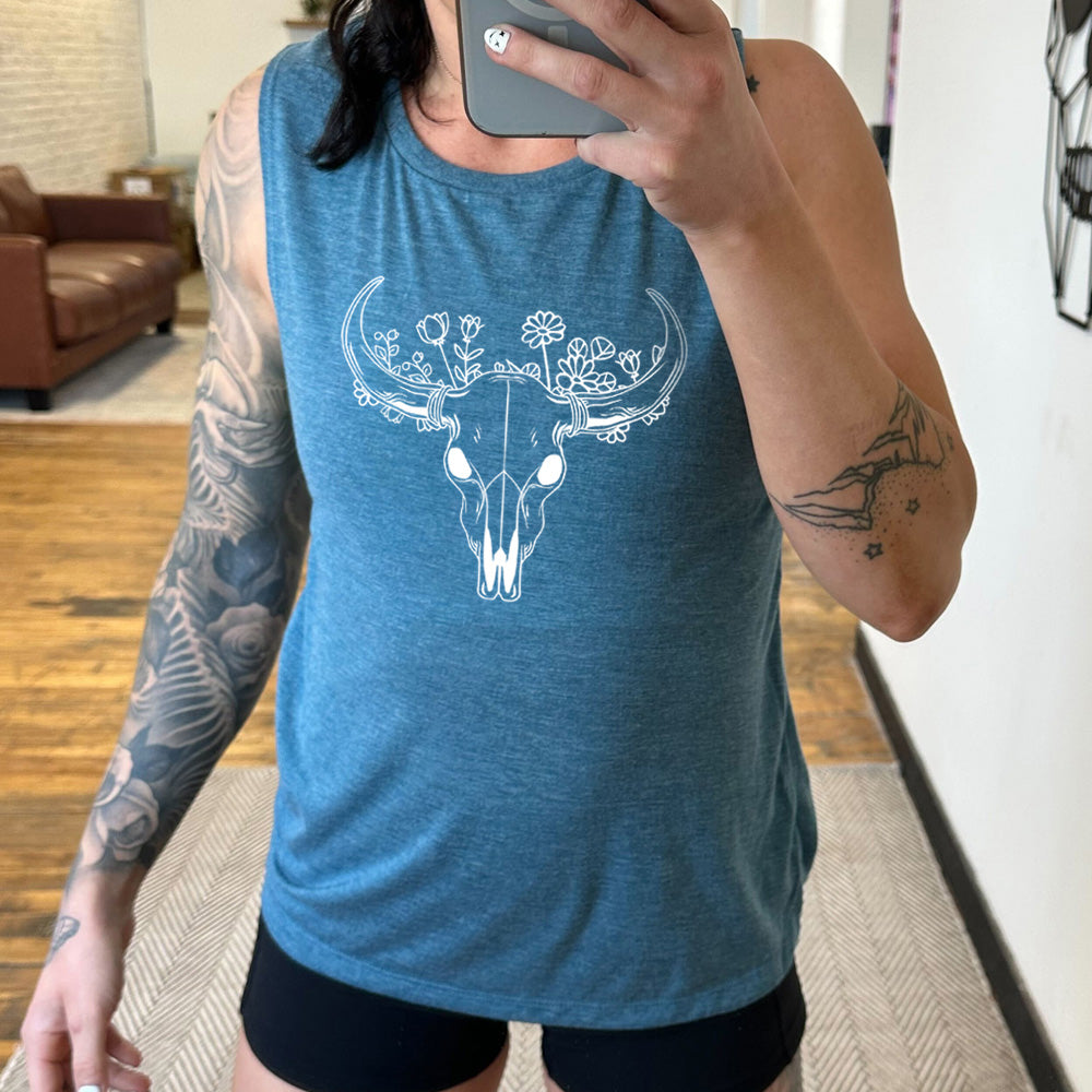 deep teal muscle tank with a floral cow skull graphic on it