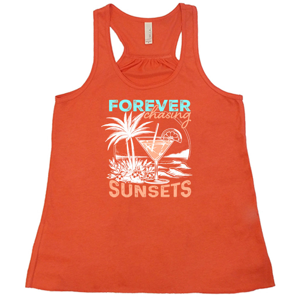 Coral colored flowy tank with a drink on the beach graphic on it that says "Forever Chasing Sunsets" 
