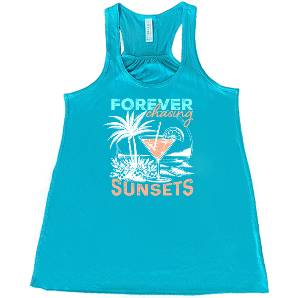 Teal colored flowy tank with a drink on the beach graphic on it that says "Forever Chasing Sunsets" 