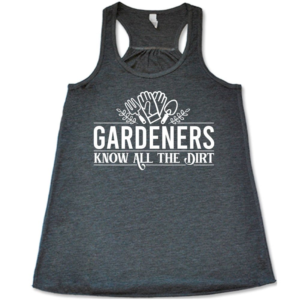 grey flowy racerback tank with the words "gardeners know all the dirt" on it, with the graphic of two gloves and two tools above the words 