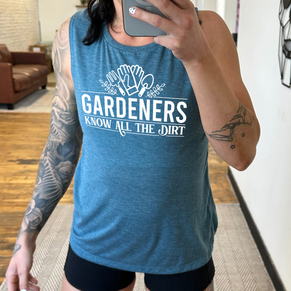 deep teal muscle tank with the words "gardeners know all the dirt" on it, with the graphic of two gloves and two tools above the words 