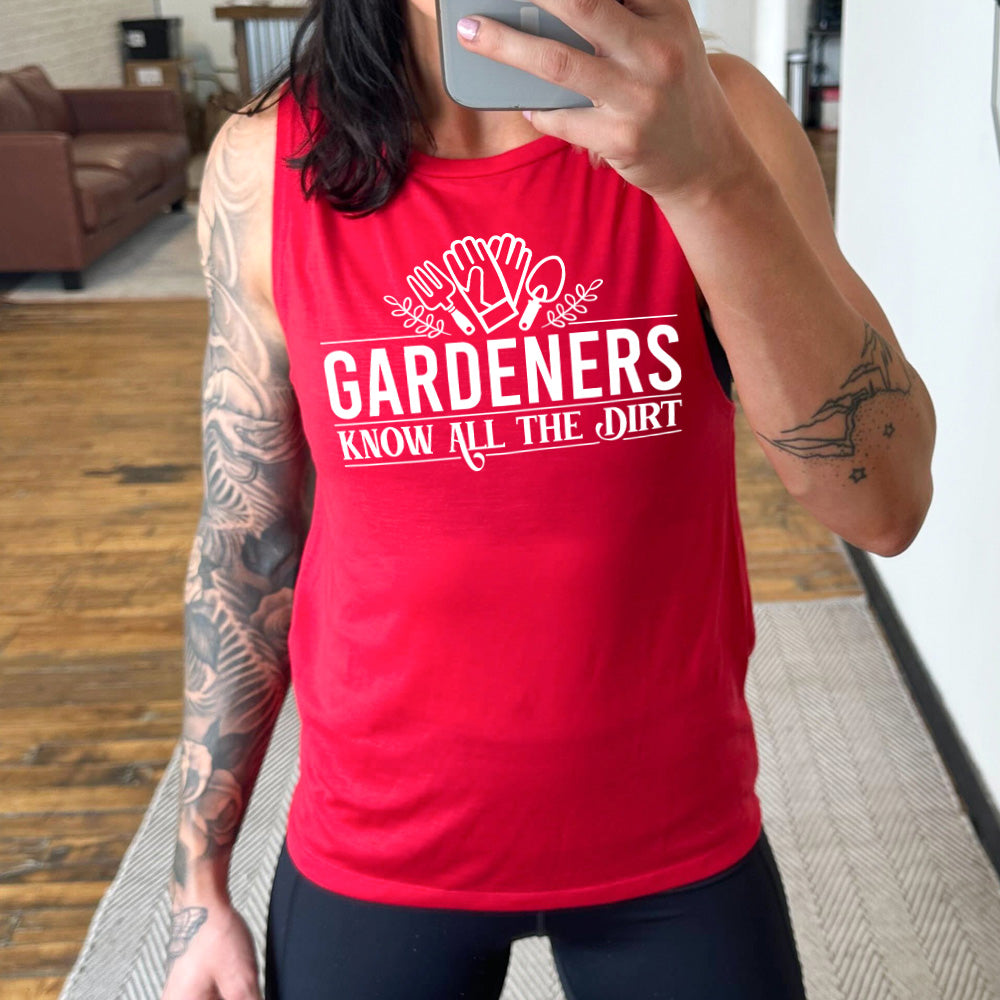 red muscle tank with the words "gardeners know all the dirt" on it, with the graphic of two gloves and two tools above the words 
