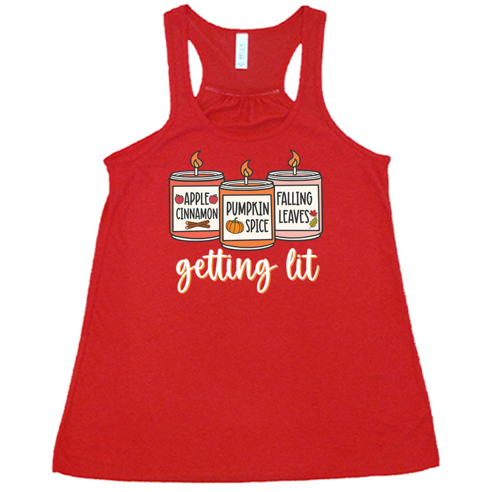 Red colored flowy tank with fall scented candles graphic on it that says "getting lit" 