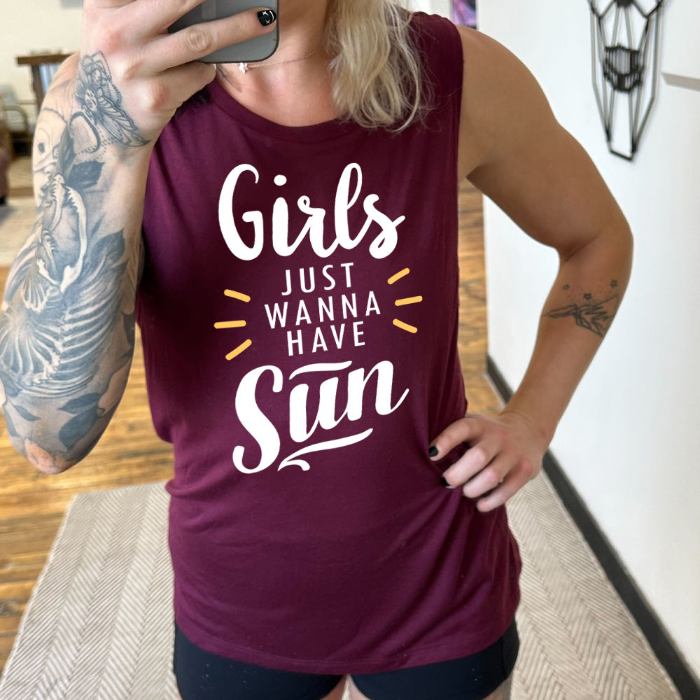 Model wearing maroon muscle tank with a sun ray graphic on it that says "Girls Just Wanna Have Sun" 