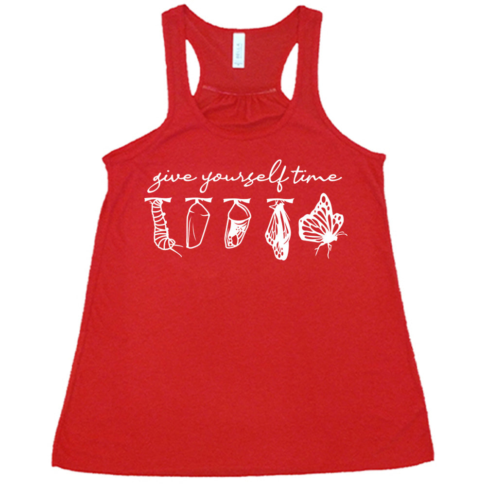 red flowy racerback tank with the graphic of the complete metamorphosis of a butterfly, with words above it saying "give yourself time"