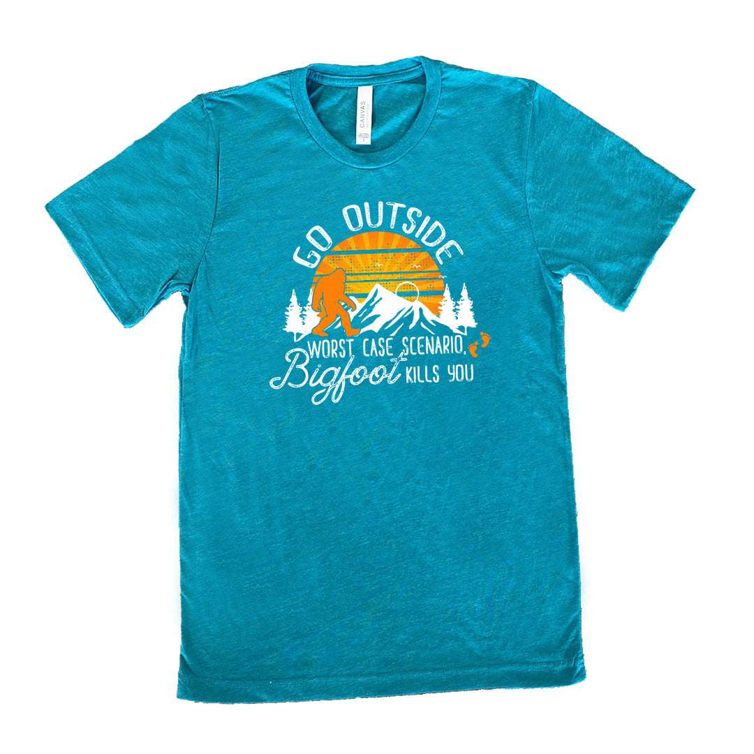 Teal colored shirt with sun and bigfoot in mountains graphic on it that says "Go Outside, Worst Case Scenario Bigfoot Kills You"