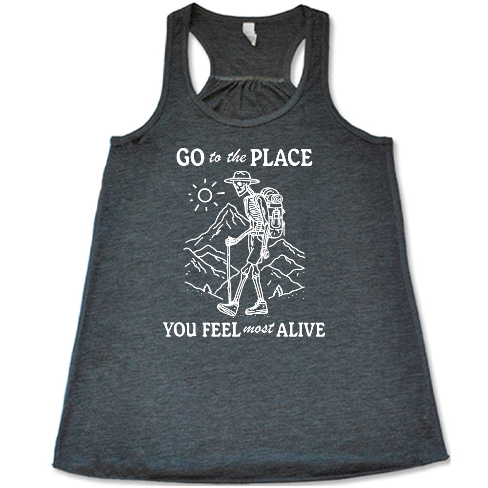 Grey colored flowy tank with a skeleton on a hike graphic on it that says "Go To The Place You Feel Most Alive" 