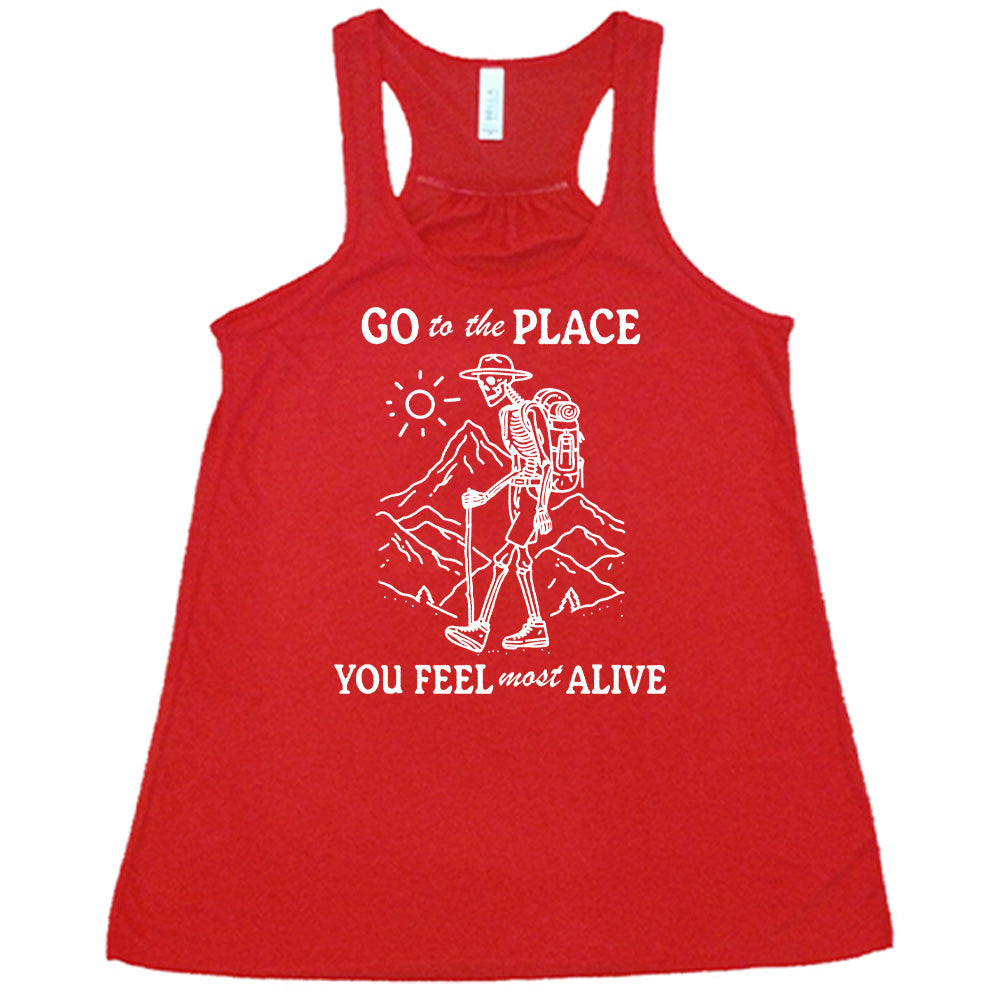 Red colored flowy tank with a skeleton on a hike graphic on it that says "Go To The Place You Feel Most Alive" 