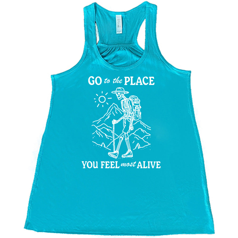 Teal colored flowy tank with a skeleton on a hike graphic on it that says "Go To The Place You Feel Most Alive" 