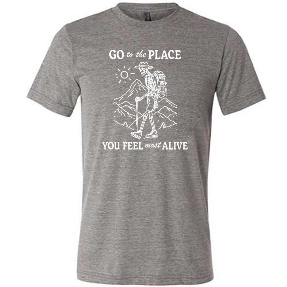Grey colored shirt with a skeleton on a hike graphic on it that says "Go To The Place You Feel Most Alive" 