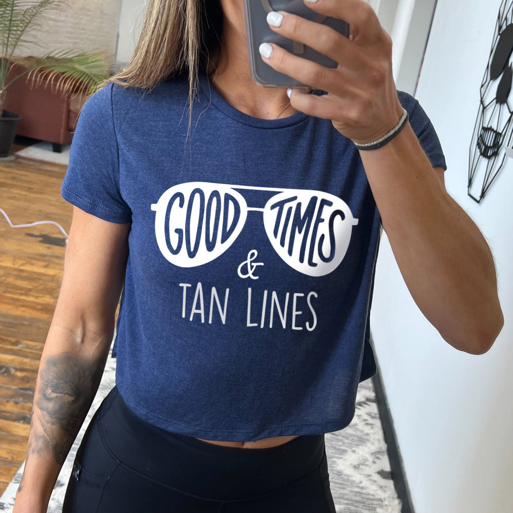 heather navy cropped tee with a sunglasses graphic on it that says "Good Times & Tan Lines" 
