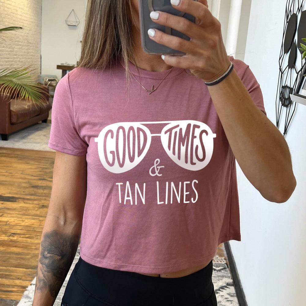 mauve cropped tee with a sunglasses graphic on it that says "Good Times & Tan Lines" 