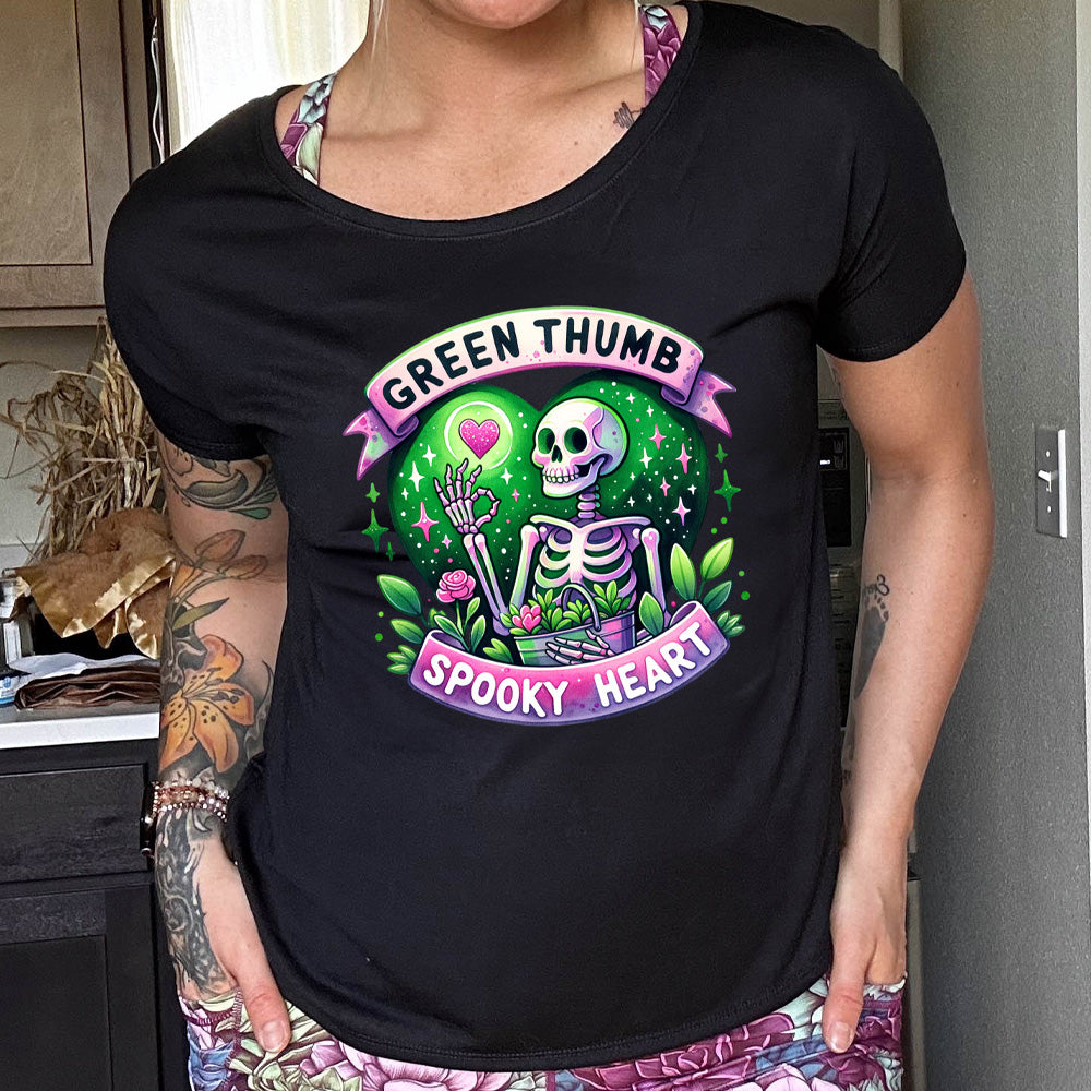 shirt with a skeleton and plants graphic on it that says "Green Thumb Spooky Heart"