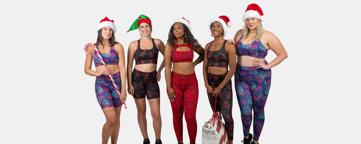 Models wearing the new christmas themed activewear sets with santa hats, candy canes, and a bag of presents