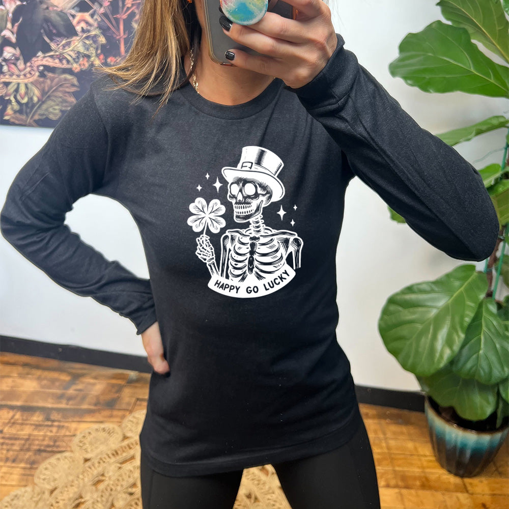 black shirt with a skeleton graphic and the text "happy go lucky" on it