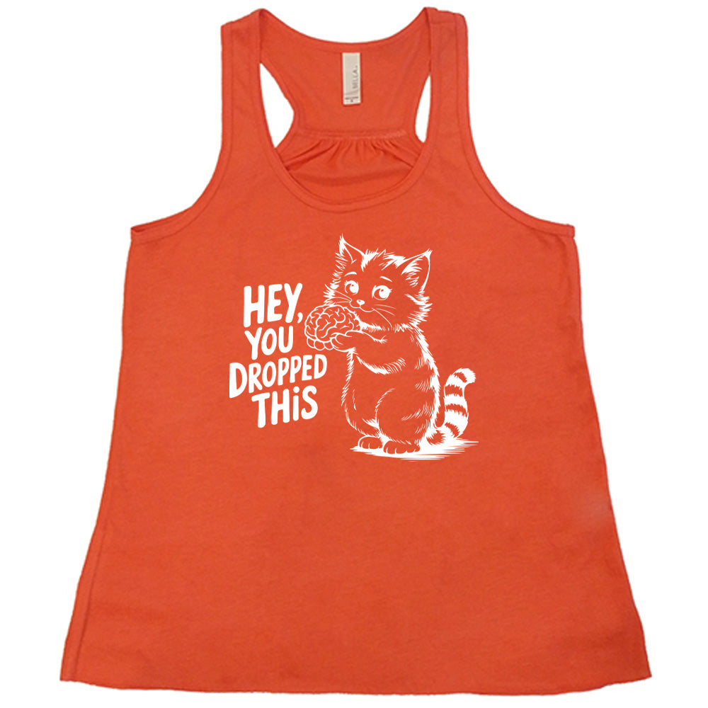 coral flowy tank with the words "Hey, you dropped this" and the graphic of a racoon holding a brain