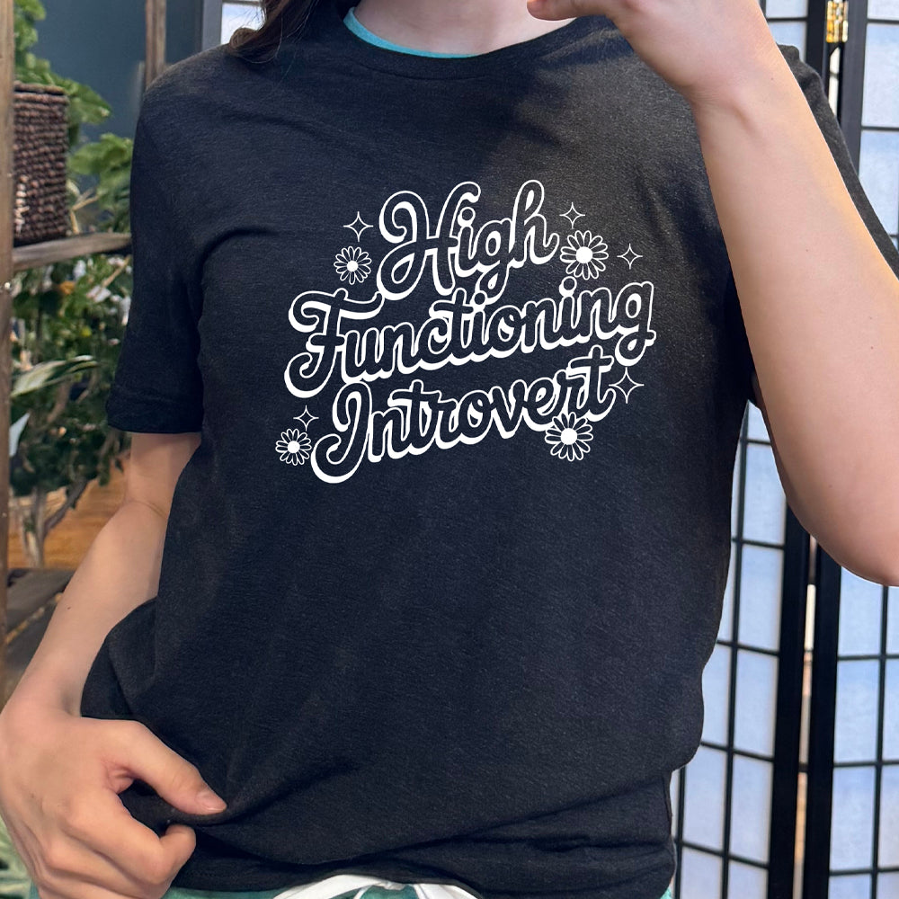 Black colored shirt with a flower graphic on it that says "High Functioning Introvert" 