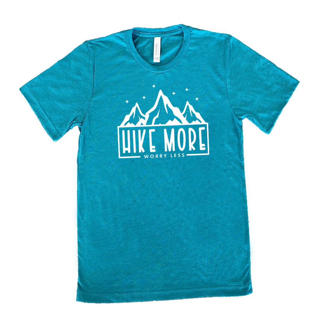 Teal colored shirt with a mountains and stars graphic on it that says "Hike More Worry Less" 