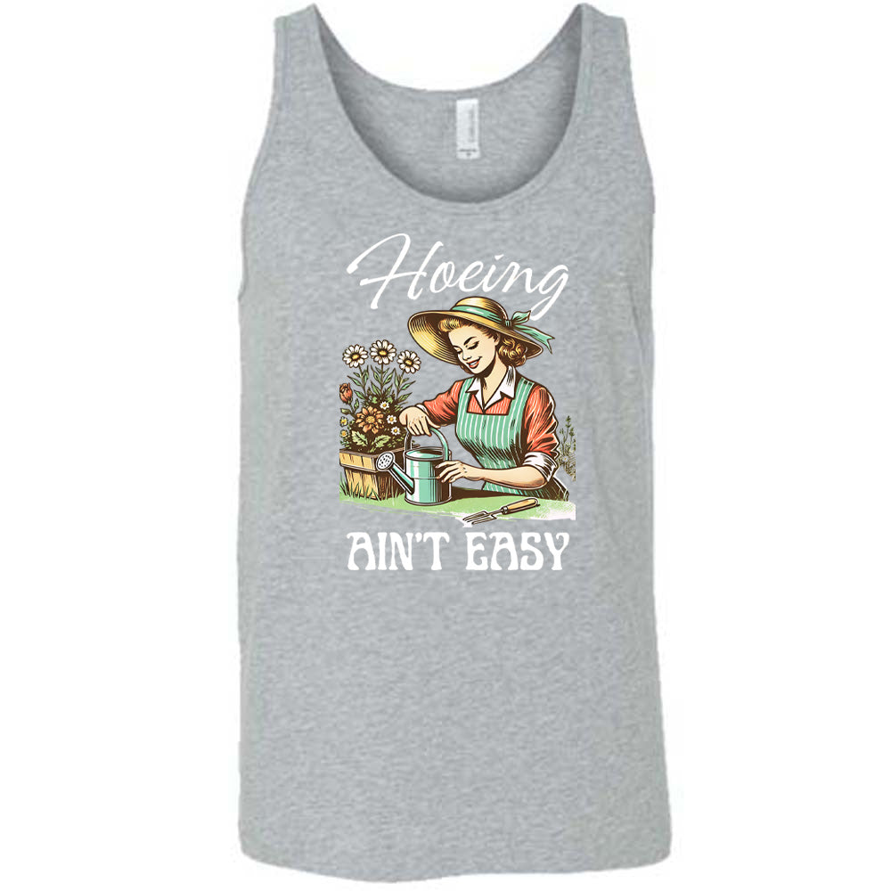 Grey colored tank with a woman gardening graphic on it that says "Hoeing Ain't Easy"
