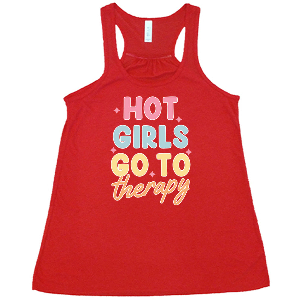 Red colored flowy tank with a sparkle graphic on it that says "Hot Girls Go To Therapy"