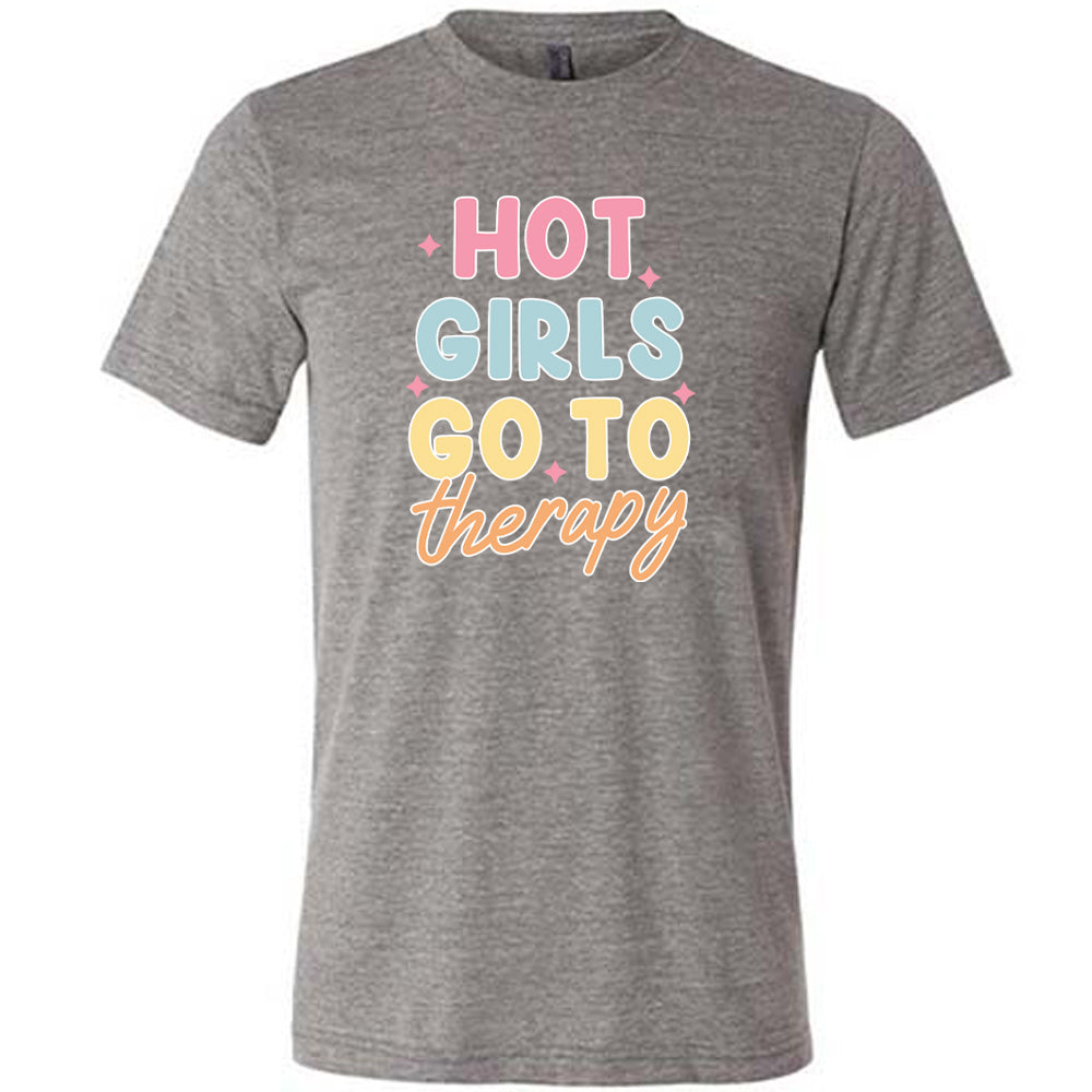 Grey colored shirt with a sparkle graphic on it that says "Hot Girls Go To Therapy"