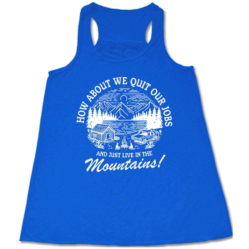 blue flowy tank with the words "How about we quit our jobs and just live in the mountains!" on it, with the graphic of a small house, a couple people sitting around a campfire, and an old car in the woods and mountains, with a sky and a couple stars and the moon