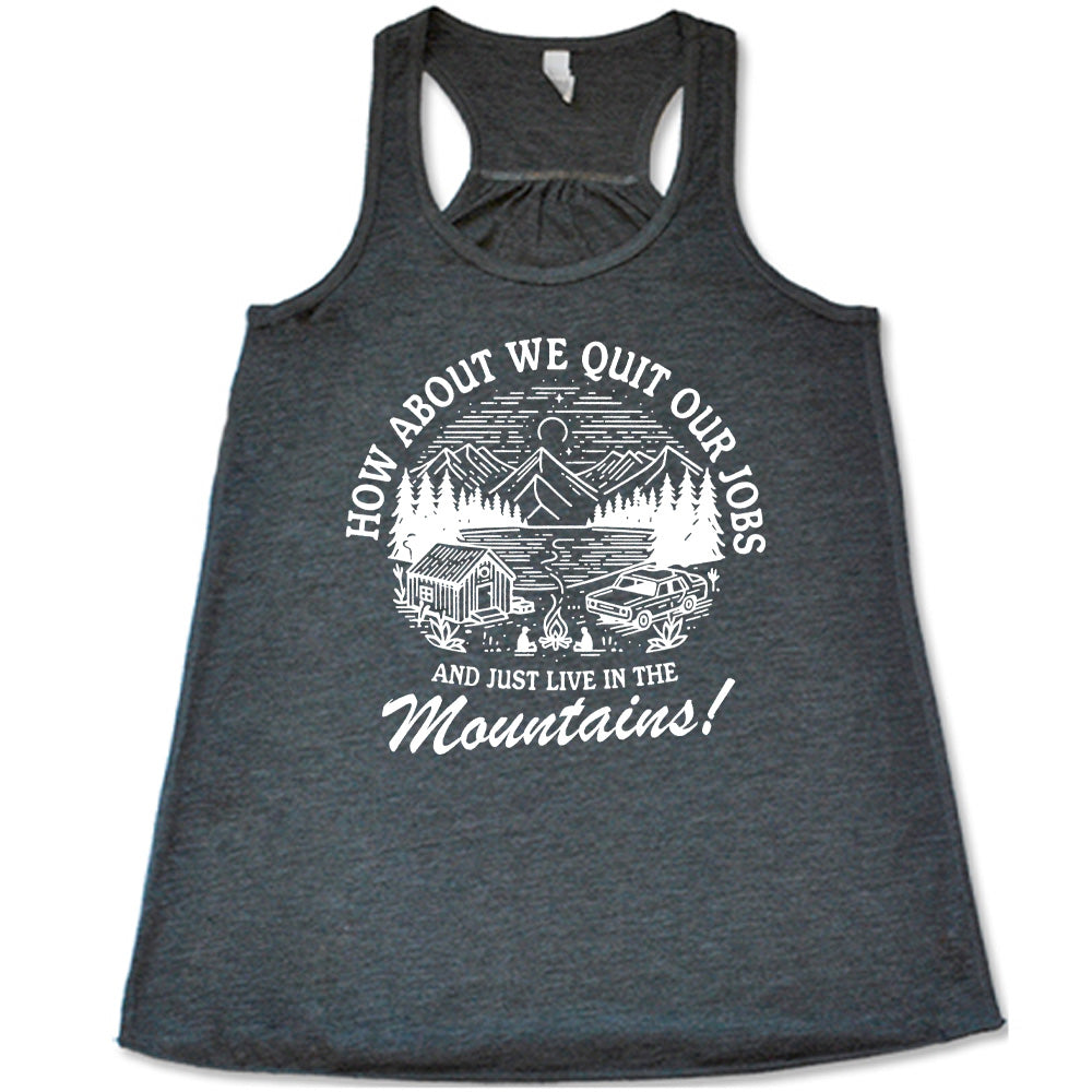 grey flowy tank with the words "How about we quit our jobs and just live in the mountains!" on it, with the graphic of a small house, a couple people sitting around a campfire, and an old car in the woods and mountains, with a sky and a couple stars and the moon