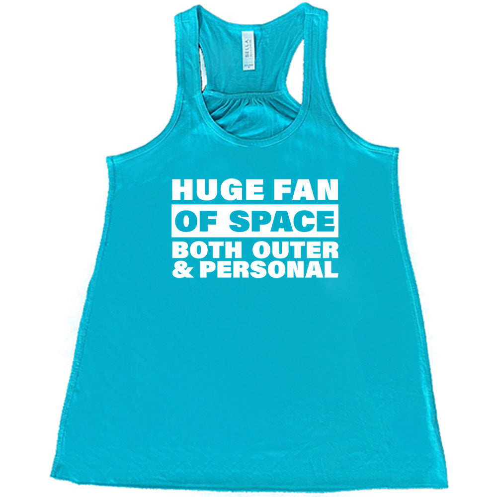 Teal colored flowy tank with a graphic on it that says "Huge Fan of Space, Both Outer and Personal" 