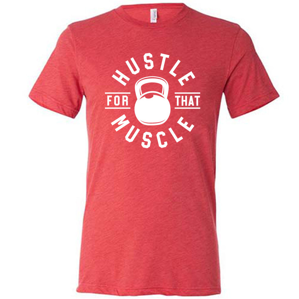 red unisex tee with the words "hustle for that muscle" on it, with a kettlebell image