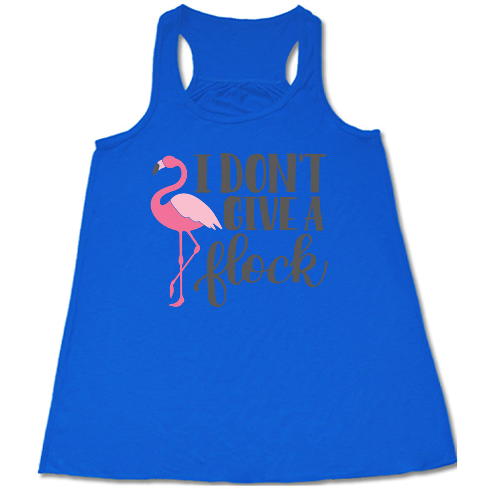 blue flowy racerback tank with the words "I don't give a flock" on it, with the graphic of a flamingo next to these words, leg raised