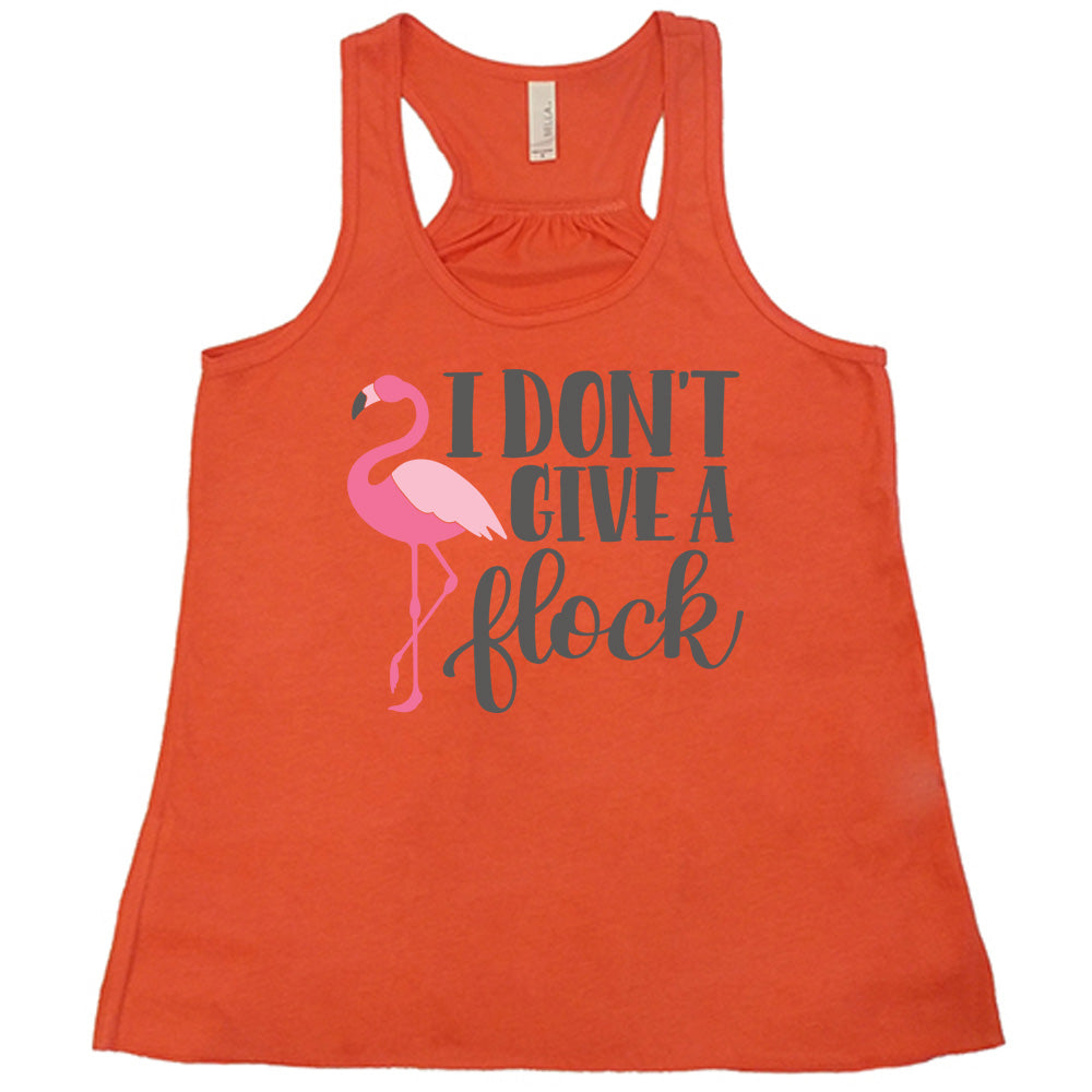 coral flowy racerback tank with the words "I don't give a flock" on it, with the graphic of a flamingo next to these words, leg raised