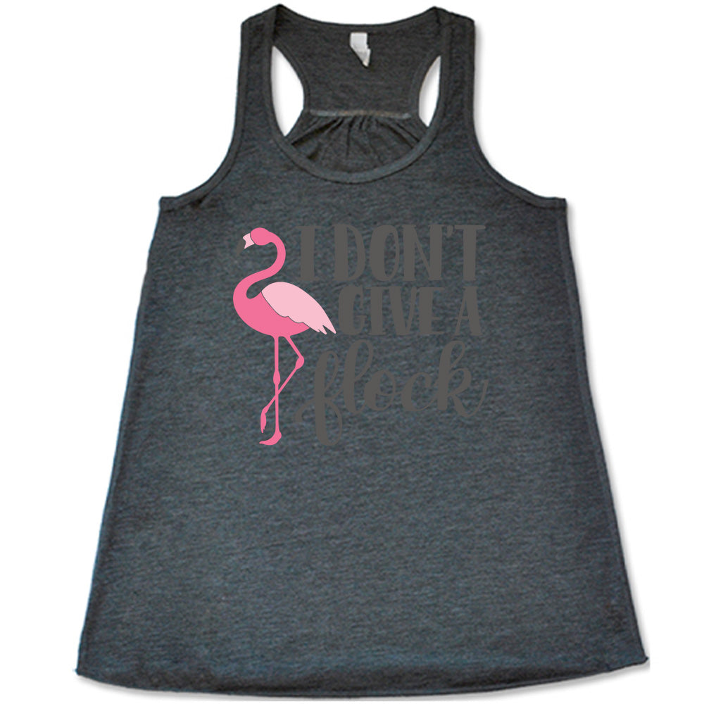 grey flowy racerback tank with the words "I don't give a flock" on it, with the graphic of a flamingo next to these words, leg raised