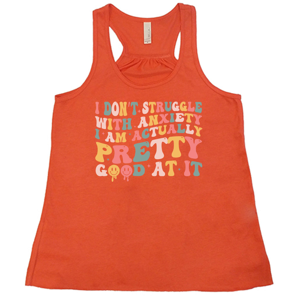 Coral colored flowy tank with a graphic on it that says "I Don't Struggle With Anxiety, I Am Actually Pretty Good At It"